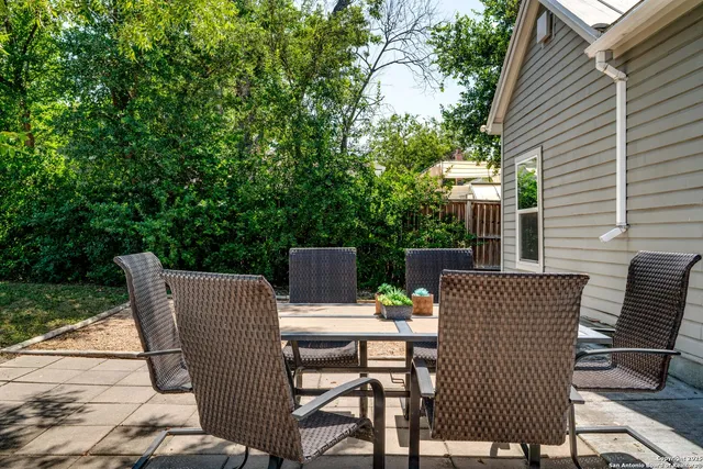 a view of backyard with seating space and trees