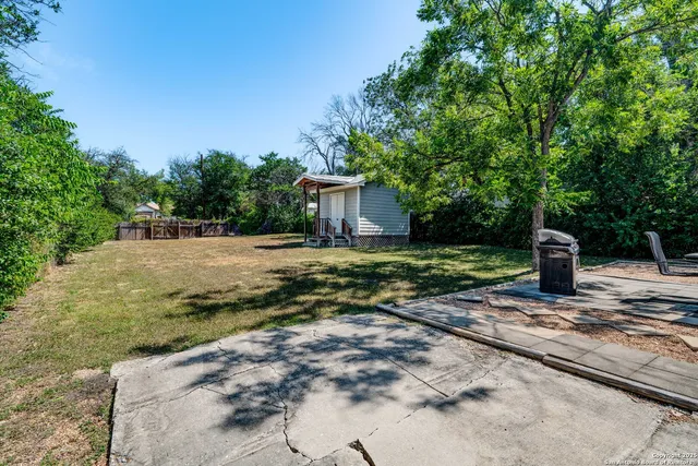 a view of a house with backyard and sitting area
