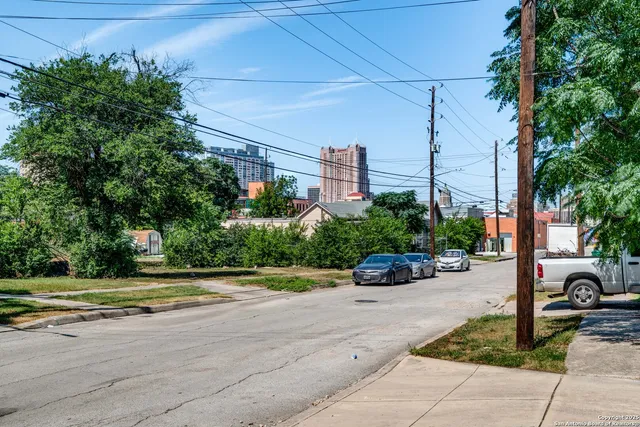 a view of a patio with a table and chairs and potted plants