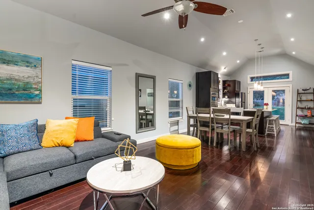a living room with furniture and wooden floor