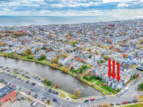a view of multiple houses with a big yard