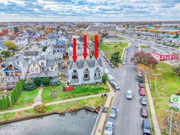 a front view of residential houses with yard and green space