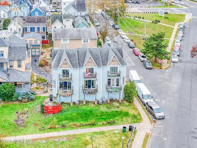 a front view of multiple houses with yard