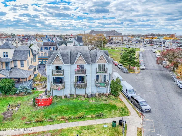 a front view of residential houses with yard and outdoor seating