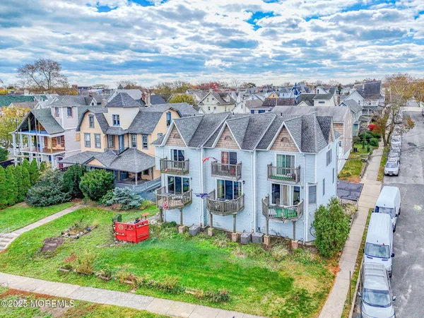 a front view of a house with cars parked
