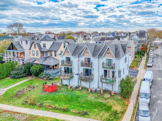 a front view of a house with cars parked