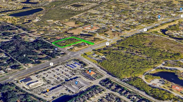 an aerial view of a house with a yard and lake view