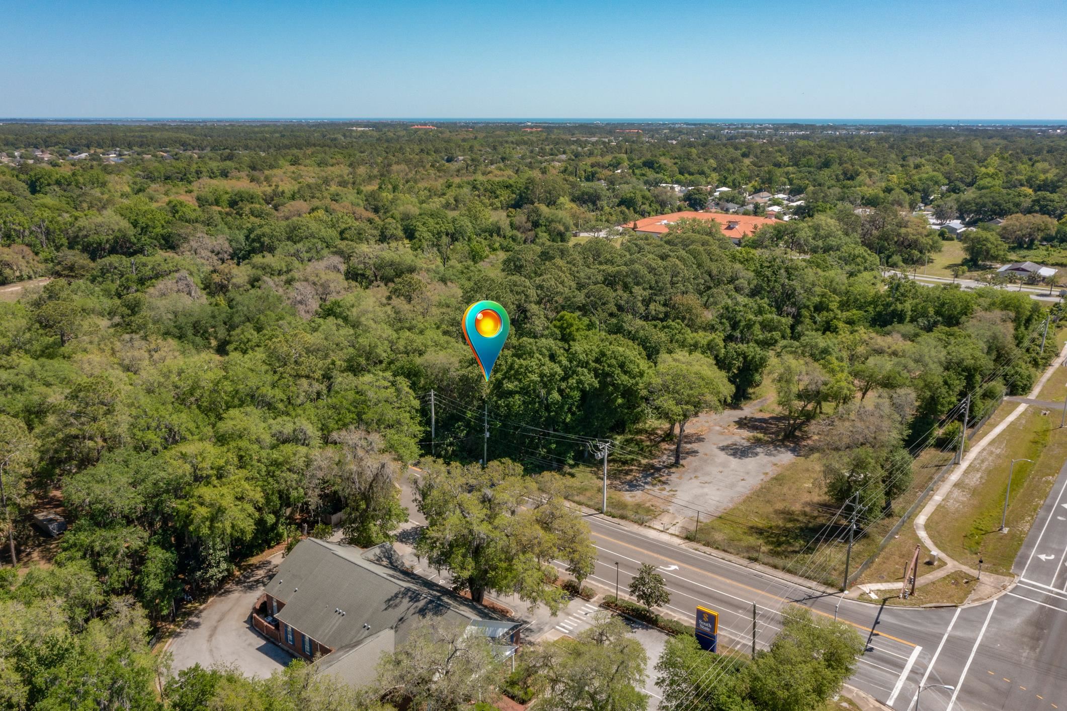 1770 Woodlawn Road St. Augustine, FL 32084 - Photo 6 of 16 an aerial view of a house with a yard and lake view