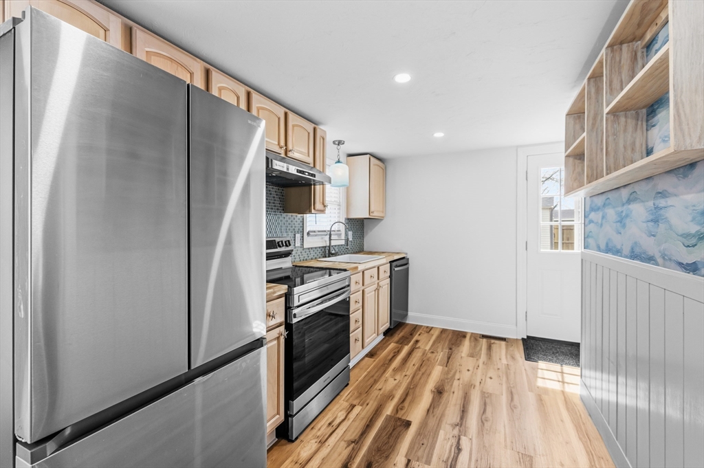 8 Cottage Street Wareham, MA 02571 - Photo 4 of 30 a kitchen with granite countertop a refrigerator stove and sink