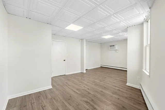 a view of empty room with wooden floor