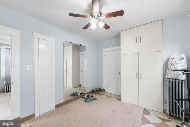 a view of a livingroom with a chandelier fan and a window