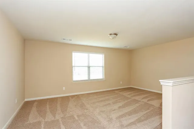 an empty room with a empty space and windows