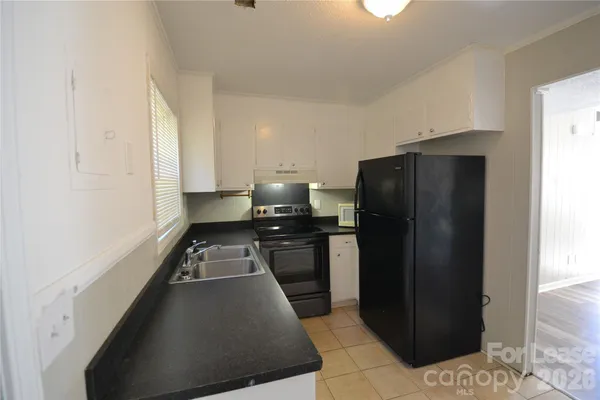 a kitchen with a refrigerator and a stove