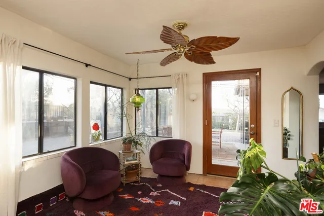 a living room with furniture and a floor to ceiling window