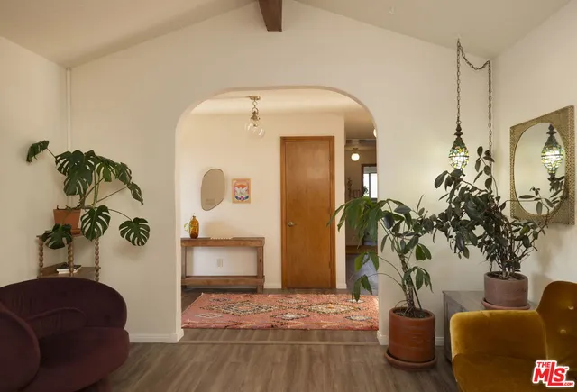 a living room with furniture and a potted plant