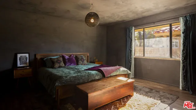 a bedroom with a bed and window