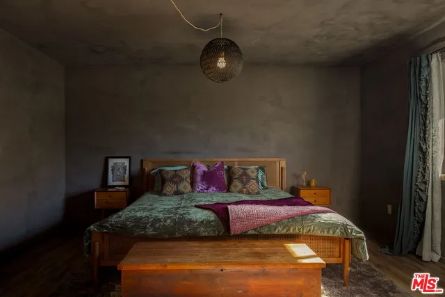 a bedroom with a bed and window