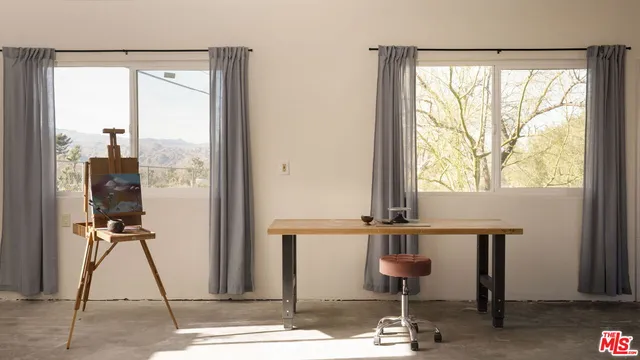 a room with gym equipment and large window