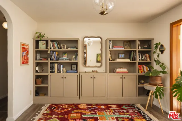 a bedroom with a bed and a book shelf