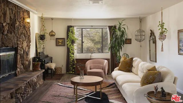 a living room with furniture and a floor to ceiling window