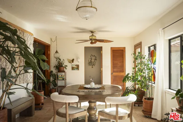 a dining room with furniture a chandelier and window
