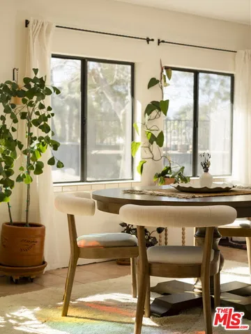 a living room filled with furniture and a potted plant