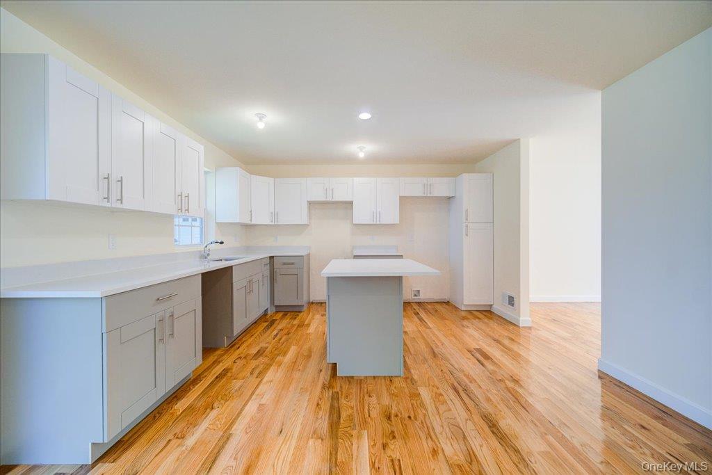 677 Marsh Road Glen Wild, NY 12738 - Photo 7 of 28 a kitchen with wooden floors and white appliances