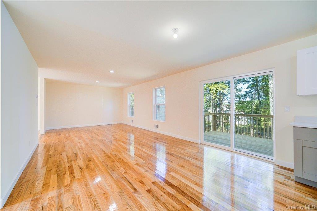 677 Marsh Road Glen Wild, NY 12738 - Photo 8 of 28 a view of an empty room with wooden floor and a window