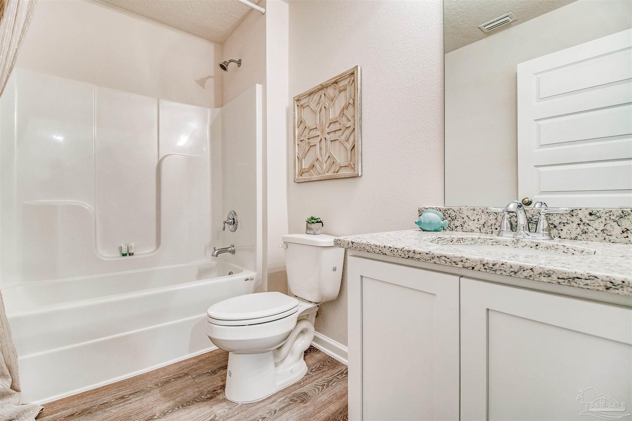 9736 Millee Loop Pensacola, FL 32526 - Photo 10 of 16 a bathroom with a granite countertop sink toilet and shower