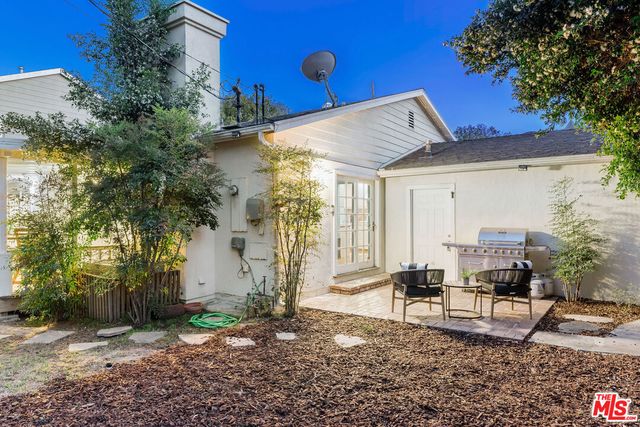 a backyard of a house with table and chairs