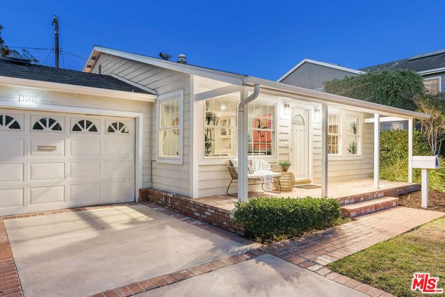 a front view of a house with a yard outdoor seating and garage