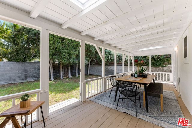a view of a patio with a table chairs and a backyard