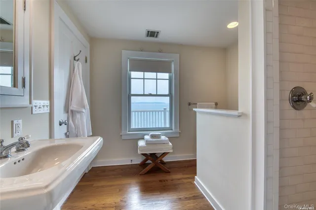 a bathroom with a tub sink and window
