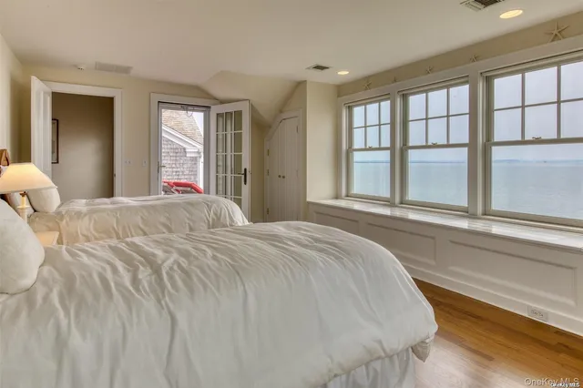 a bedroom with a large bed and a large window