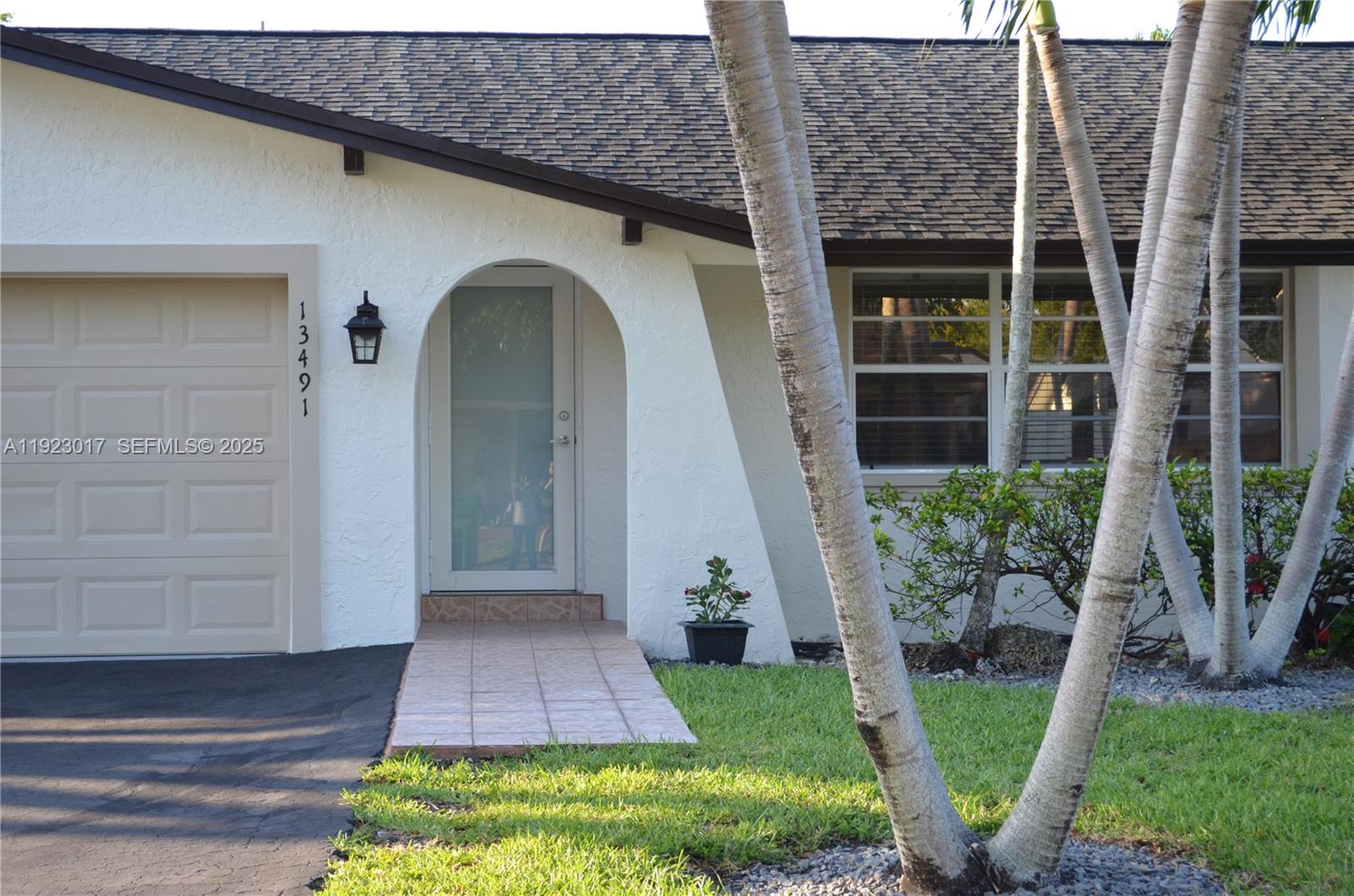 a front view of a house with garden