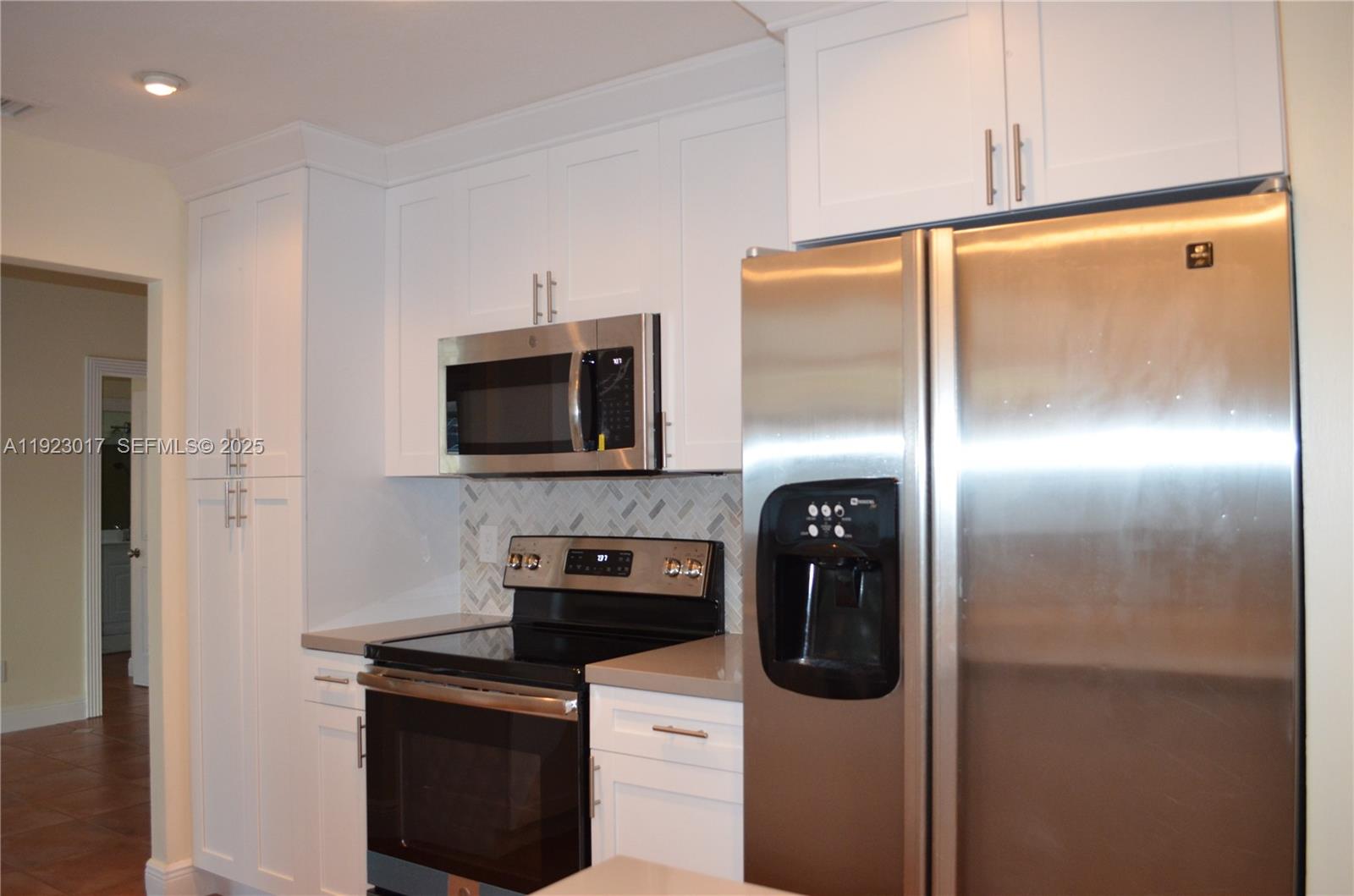 13491 Southwest 99th Terrace Miami, FL 33186 - Photo 15 of 41 a kitchen with stainless steel appliances granite countertop a refrigerator and a stove