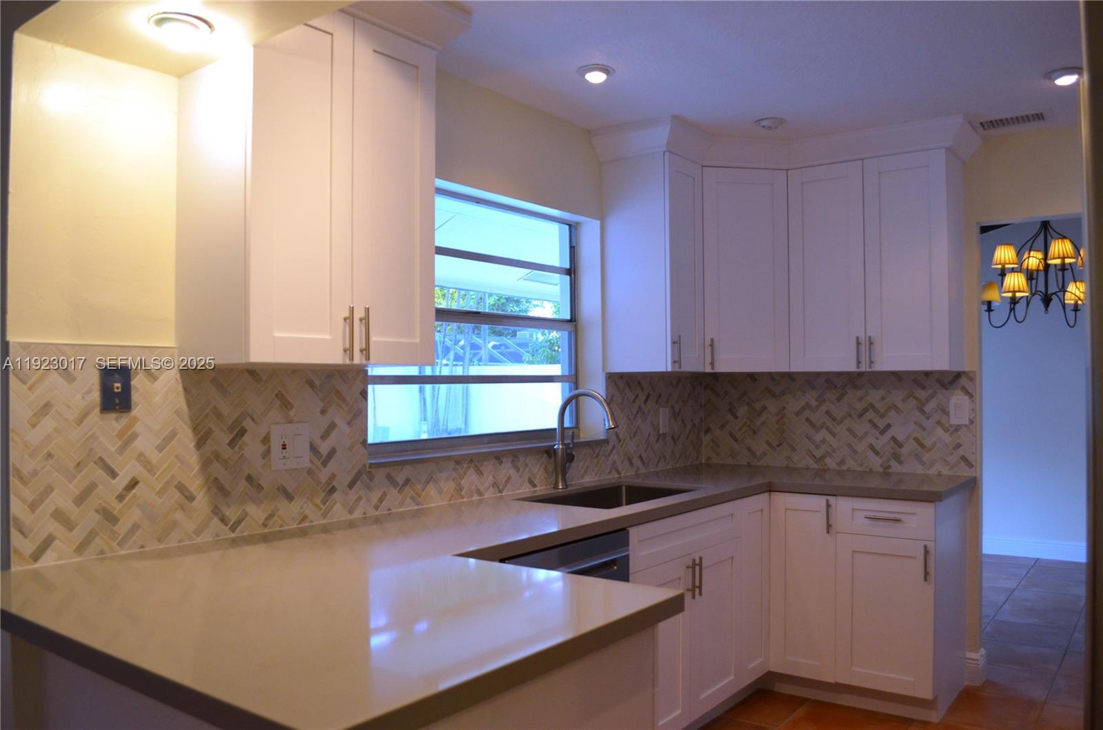 13491 Southwest 99th Terrace Miami, FL 33186 - Photo 19 of 41 a kitchen with stainless steel appliances granite countertop a sink a stove and a microwave