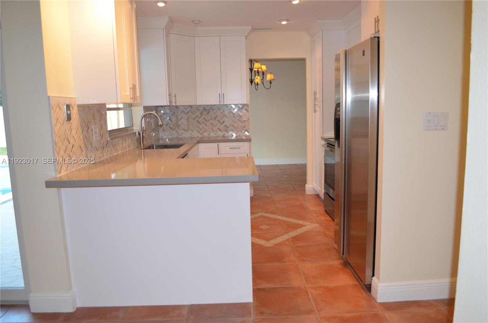 13491 Southwest 99th Terrace Miami, FL 33186 - Photo 20 of 41 a kitchen with stainless steel appliances granite countertop a sink and a refrigerator