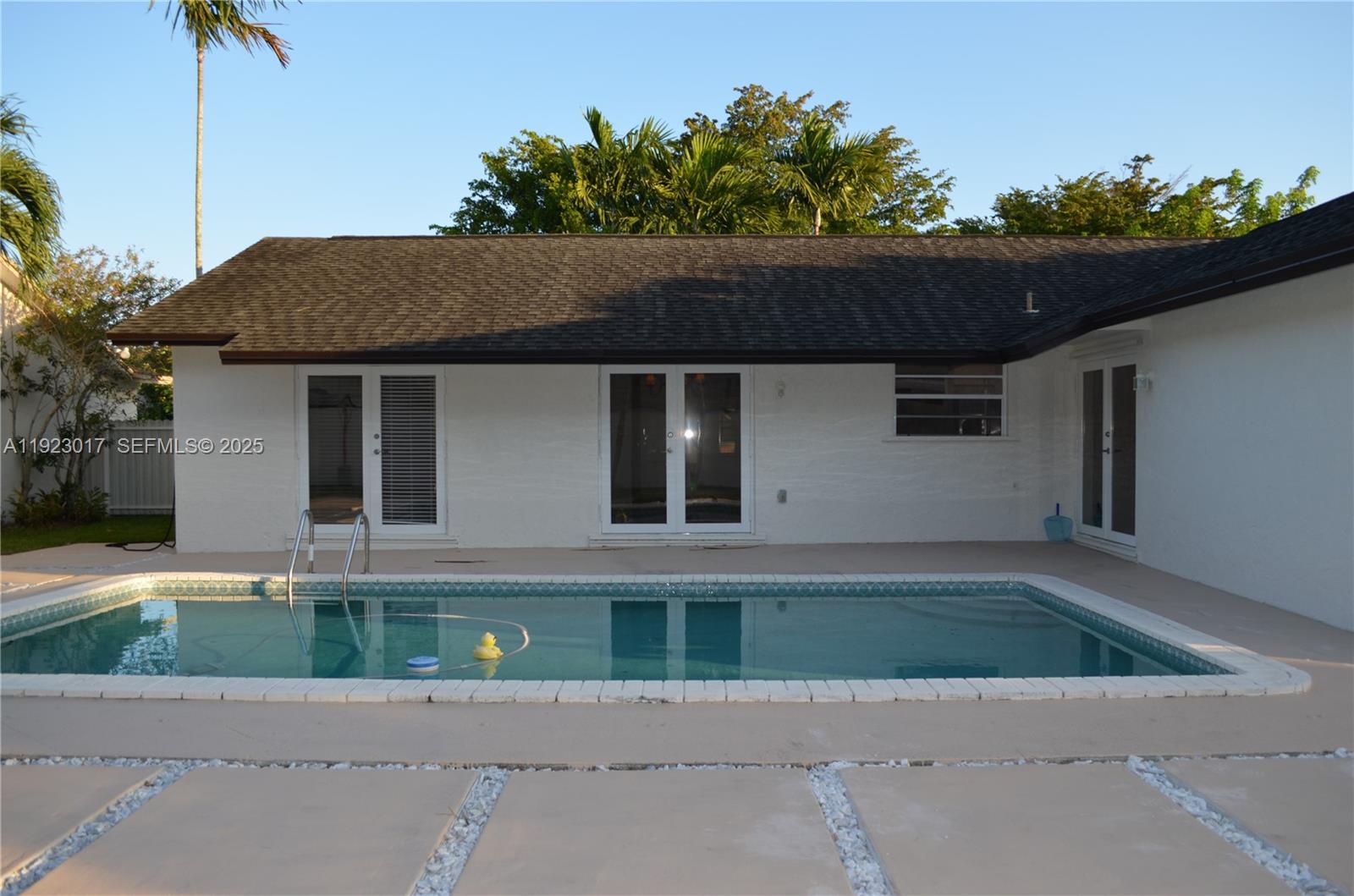 13491 Southwest 99th Terrace Miami, FL 33186 - Photo 23 of 41 a front view of a house with a yard