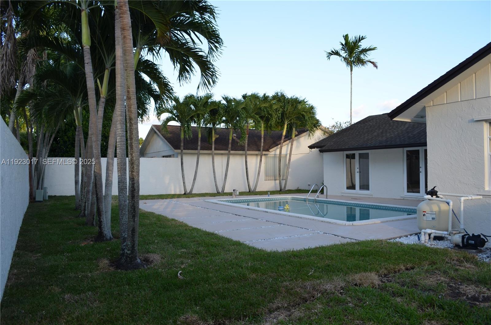 13491 Southwest 99th Terrace Miami, FL 33186 - Photo 25 of 41 a front view of a house with a garden and yard