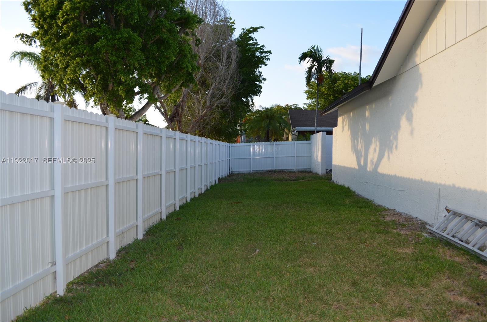 13491 Southwest 99th Terrace Miami, FL 33186 - Photo 27 of 41 a view of a backyard with potted plants and wooden fence