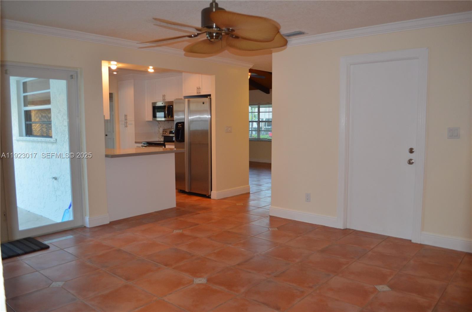 13491 Southwest 99th Terrace Miami, FL 33186 - Photo 36 of 41 a view of a kitchen with a refrigerator a sink a kitchen space and windows
