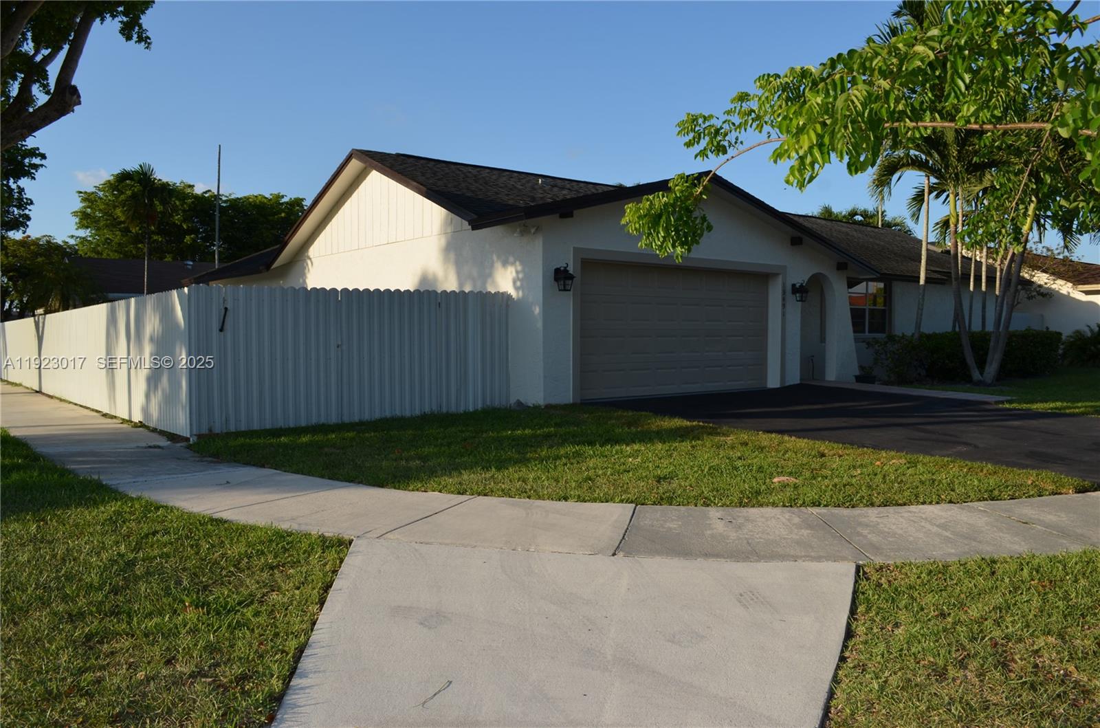 13491 Southwest 99th Terrace Miami, FL 33186 - Photo 38 of 41 a front view of a house with a yard and garage