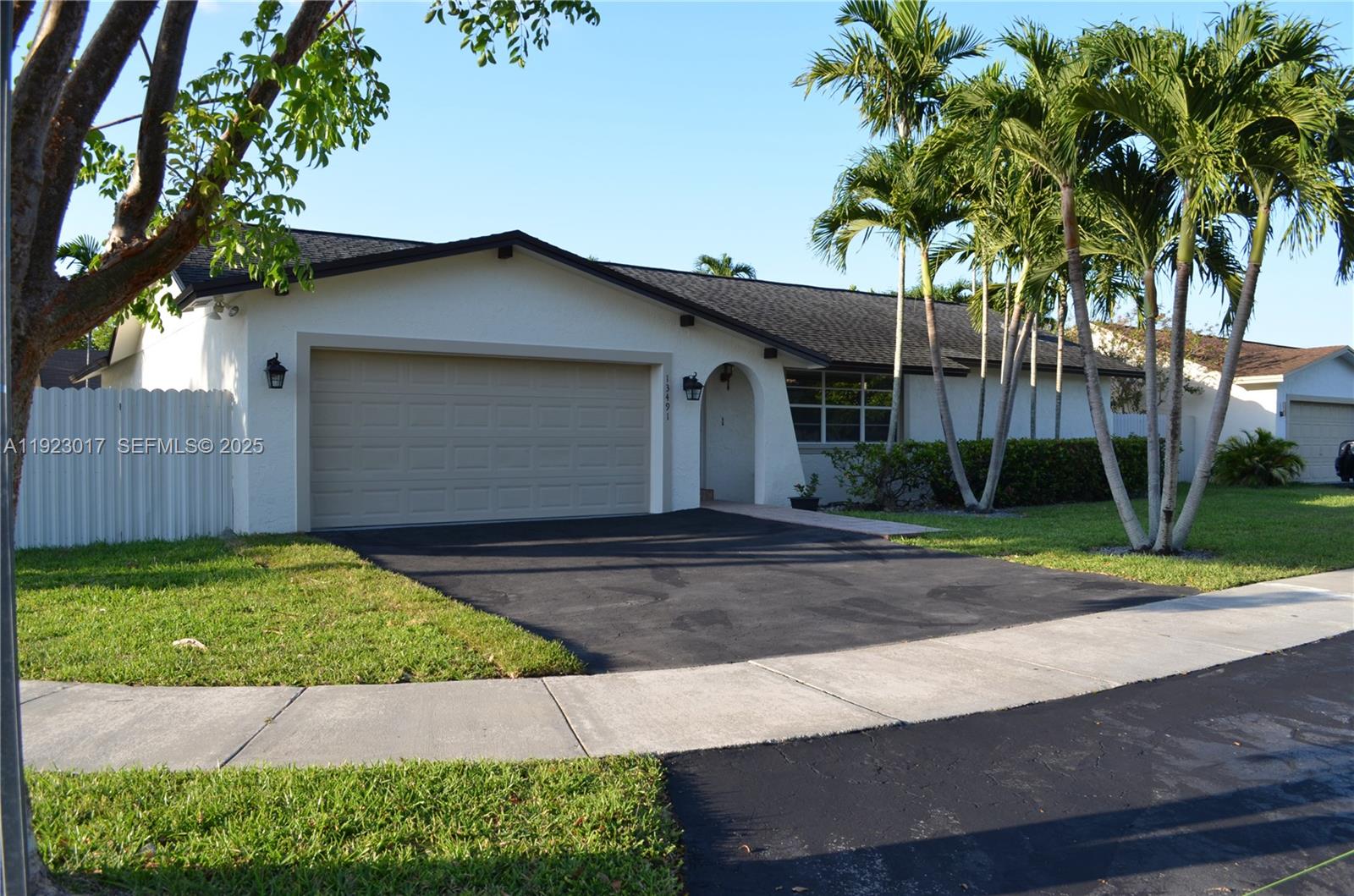 13491 Southwest 99th Terrace Miami, FL 33186 - Photo 39 of 41 a front view of a house with a yard and garage