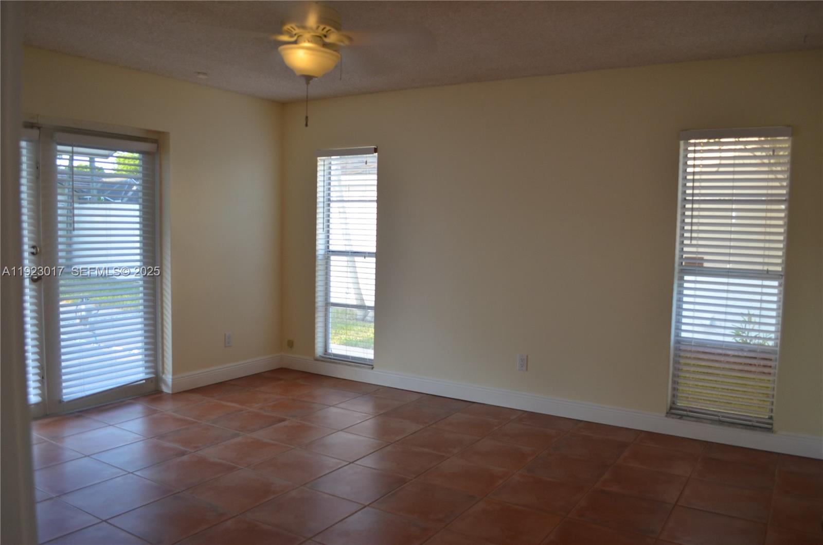 13491 Southwest 99th Terrace Miami, FL 33186 - Photo 5 of 41 a view of an empty room with a window