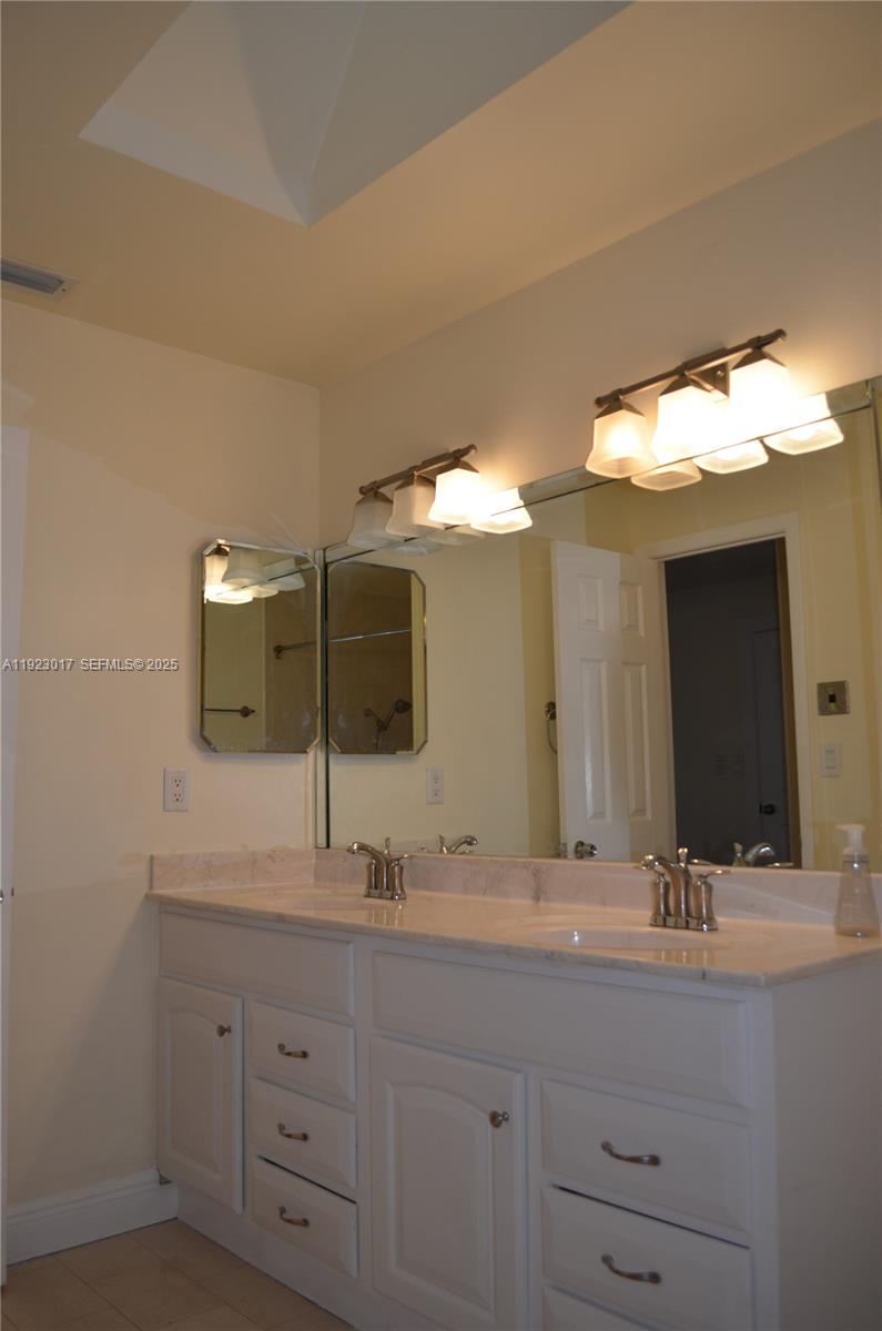 13491 Southwest 99th Terrace Miami, FL 33186 - Photo 7 of 41 a bathroom with a double vanity sink and a mirror