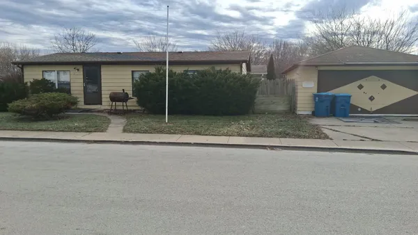 a view of a house with a yard and a garage