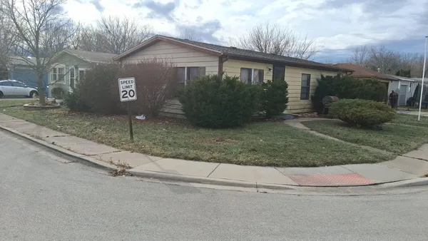a front view of house with yard and green space