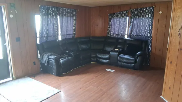 a view of a livingroom with furniture and staircase