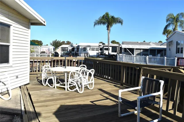 a view of a roof deck with table and chairs
